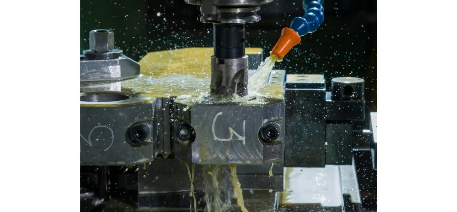 CNC milling of a carbon steel component with flood coolant applied to the end mill