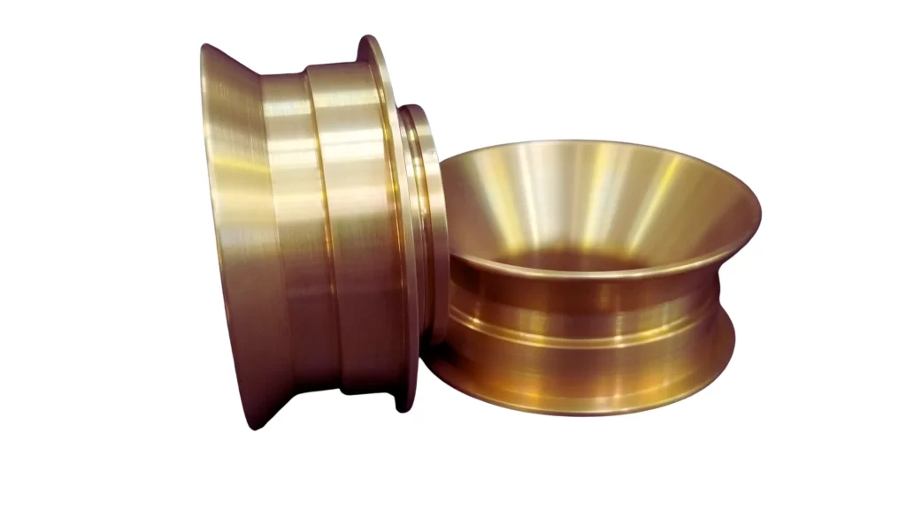 Image of custom metal parts showing chromate-coated surfaces with Alodine treatment, providing enhanced corrosion resistance.