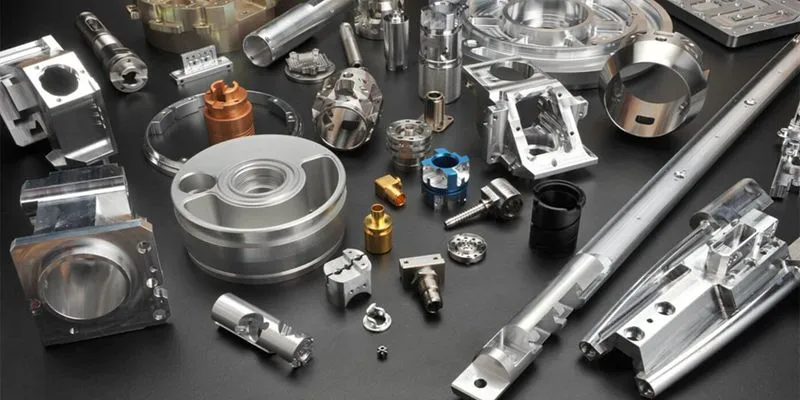 Precision-machined metal components and parts on a dark surface before assembly