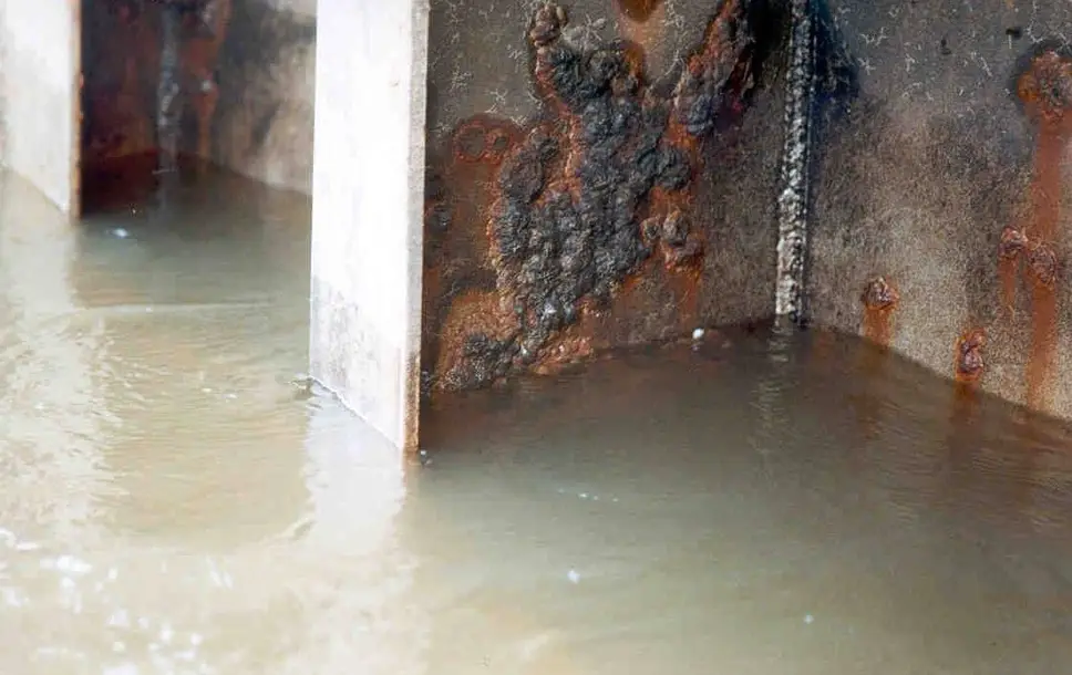 Water-damaged steel structure with rust and corrosion from moisture exposure in a flooded environment