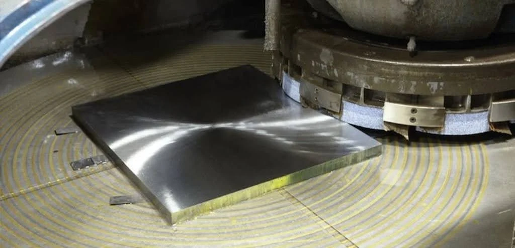 A close-up view of rotary surface grinding for a large machine base