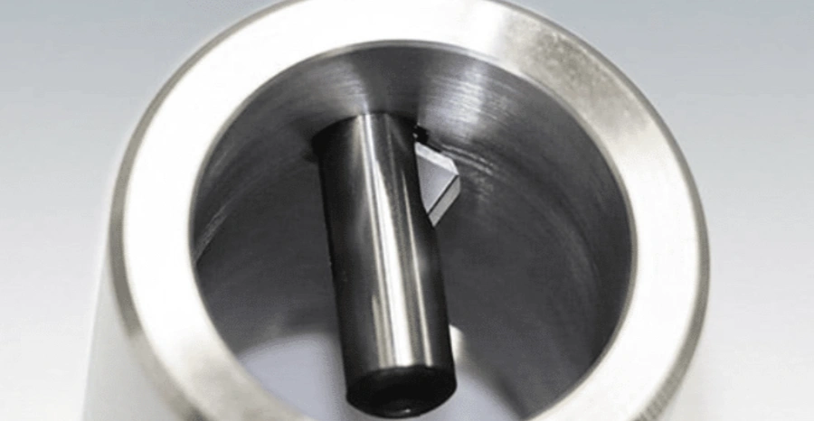 Abrasive flow machining deburring internal holes in a metal part