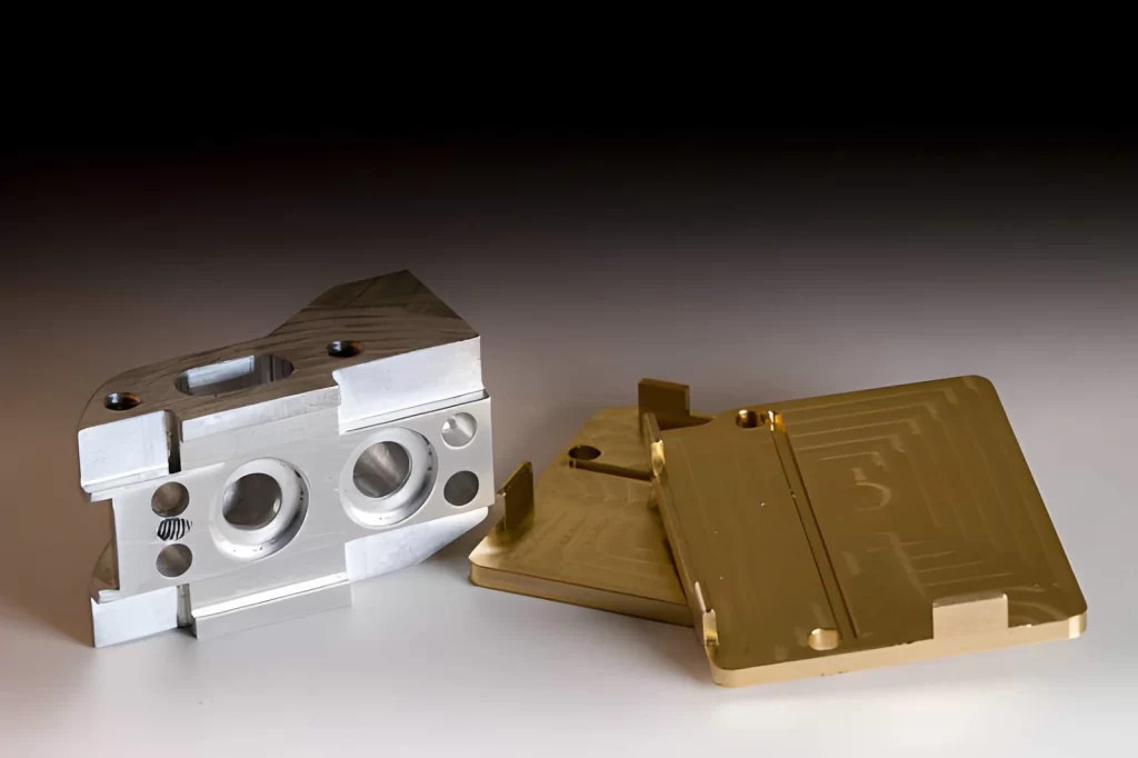 The image shows CNC-machined metal components with a phosphate conversion coating.