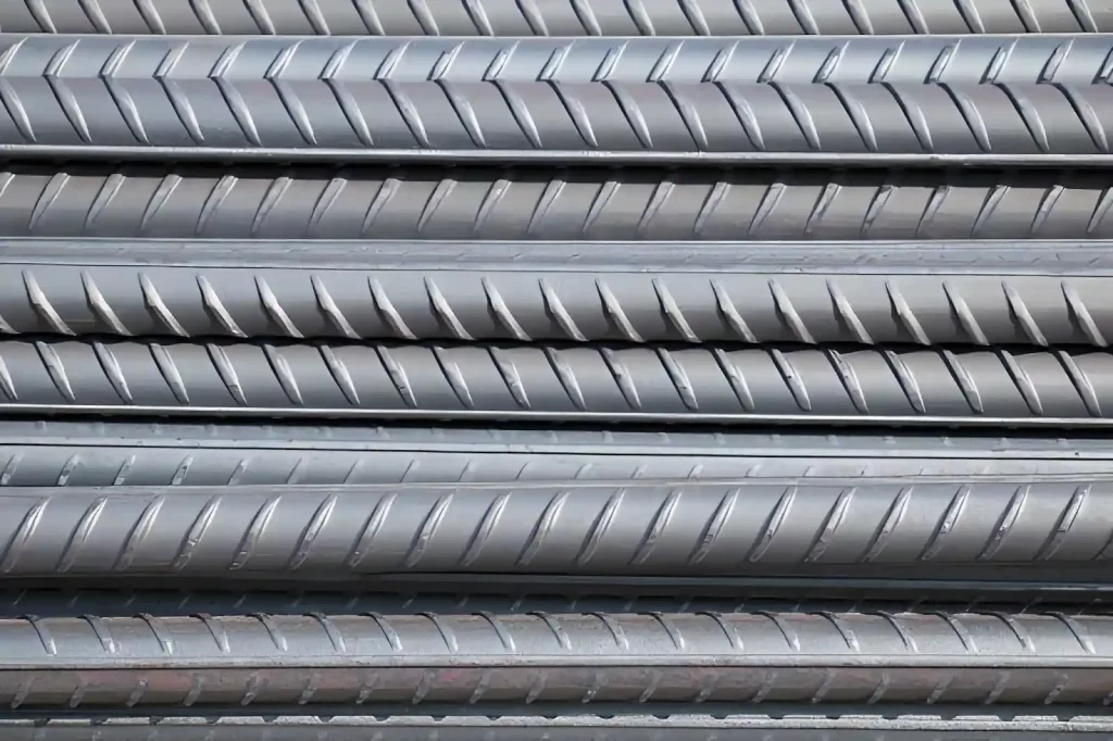 Ribbed high carbon steel bars showing a strong surface pattern for structural and mechanical use.