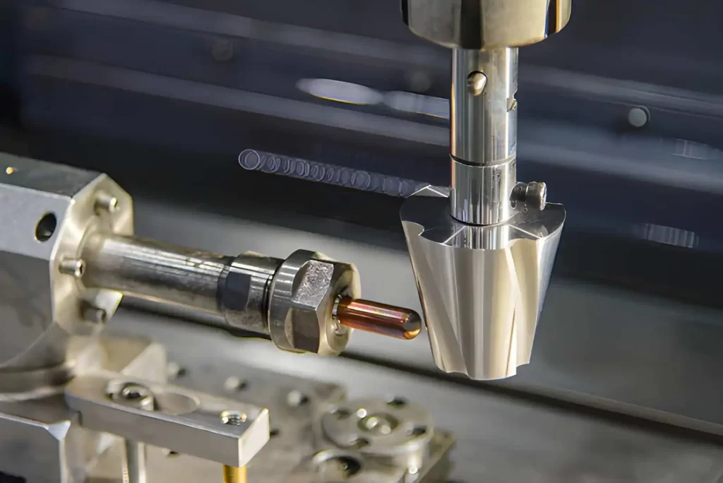 The image shows a sinker EDM machine operating with a copper electrode to machine a metal workpiece.