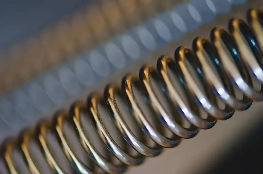 A close up of coiled steel spring made from high carbon steel.