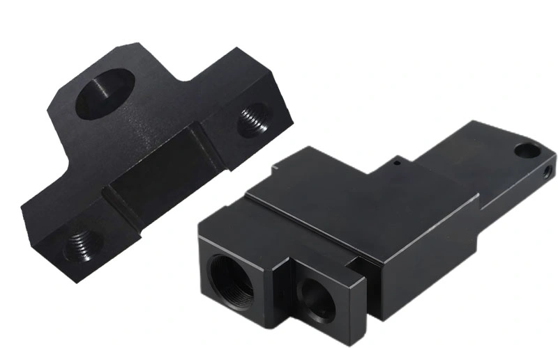 Two black-anodized aluminum parts