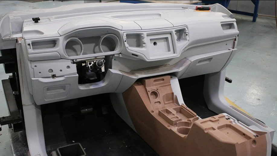 Unpainted injection-molded car dashboard and center console prototype parts