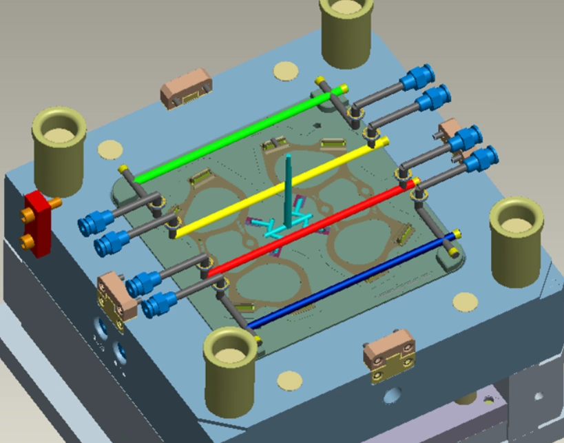 3D CAD model of an injection mold cooling system showing color-coded cooling channels routed across the mold plate with fittings and connectors