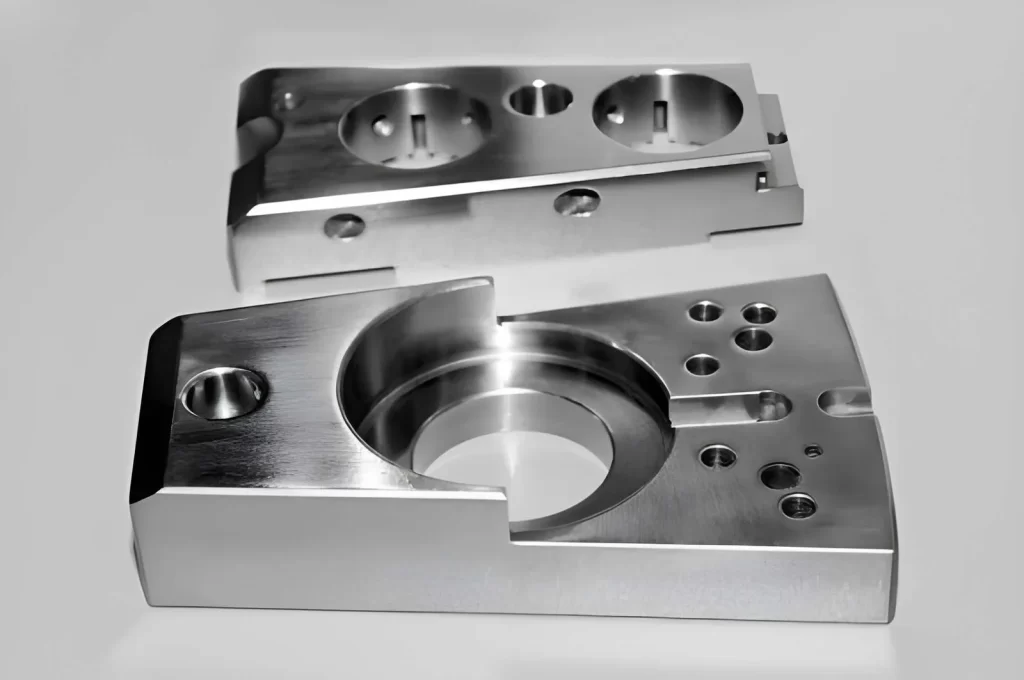 Industrial rectangular 316 stainless steel part with round holes, shown in black and white with a shallow depth of field.