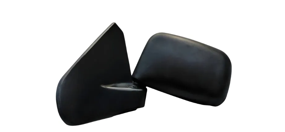 A side-view mirror housing for a vehicle, molded from matte black ABS plastic to provide high impact resistance