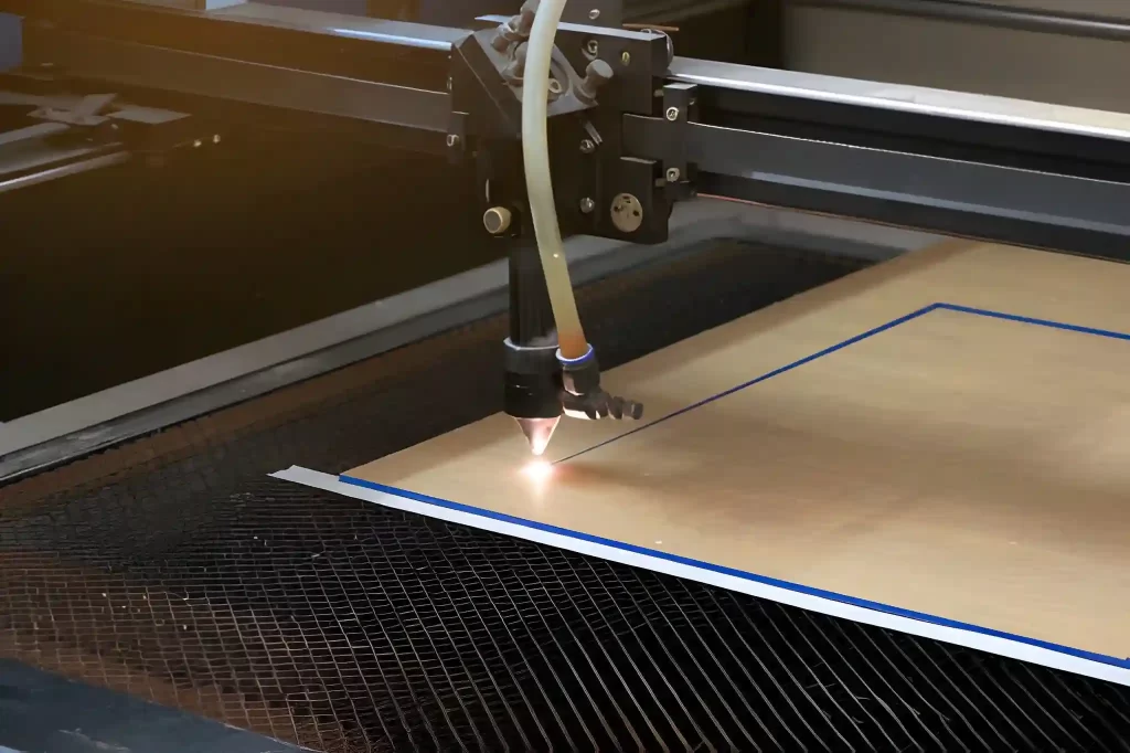 A CO2 laser cutter in action, cutting through an opaque plastic sheet.