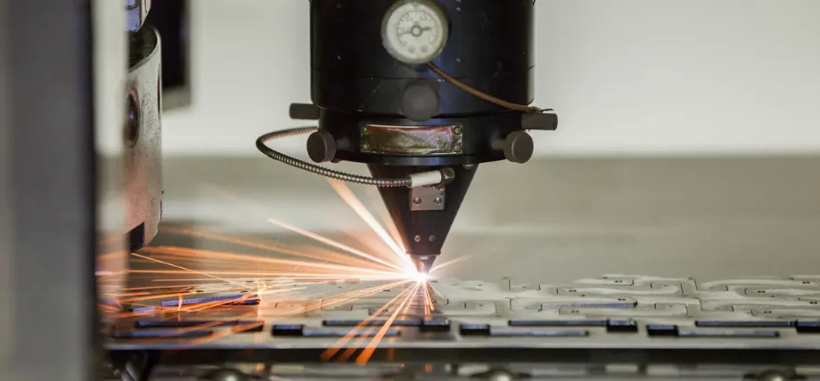 Laser cutting beam focused on steel with spark