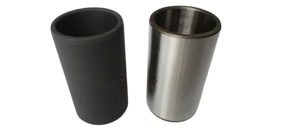 Two cylindrical metal sleeves side-by-side; one has a matte black oxide finish while the other shows a bright, machined steel surface