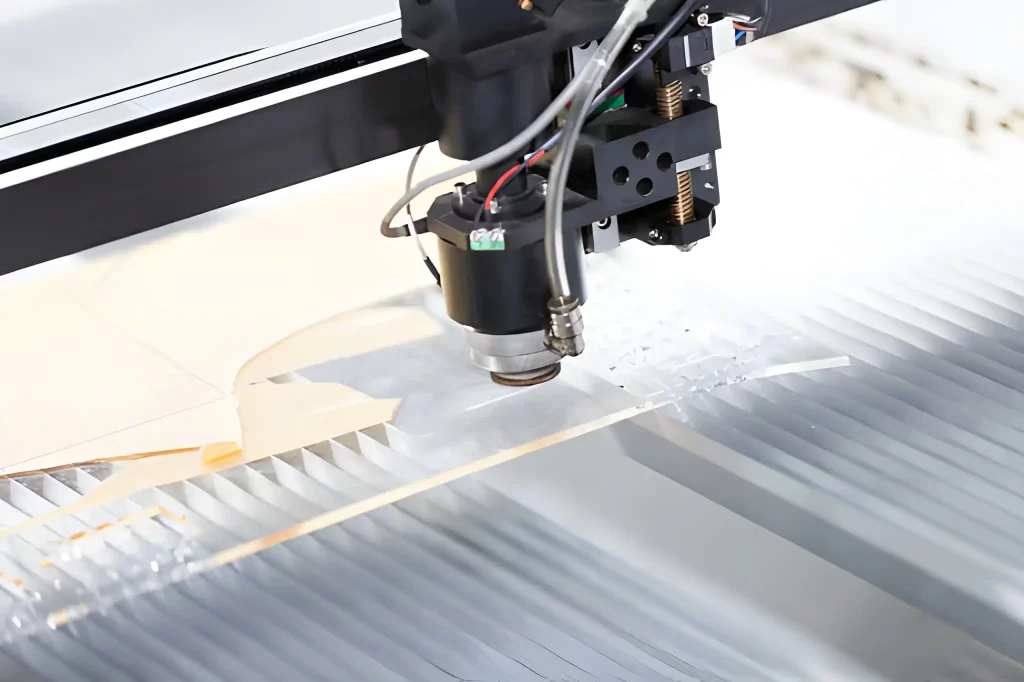A transparent plastic sheet being precisely cut with a laser.