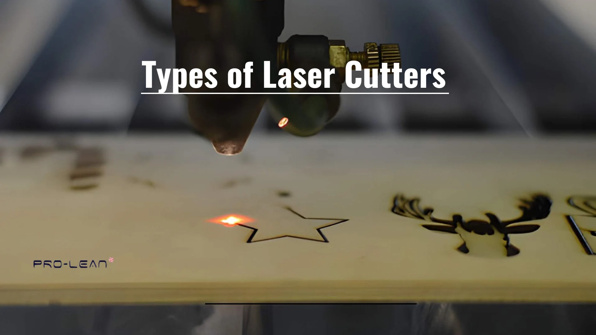 Feature image showing a laser cutting machining operating on a wood sheet with overlaid text (Types of laser cutters)
