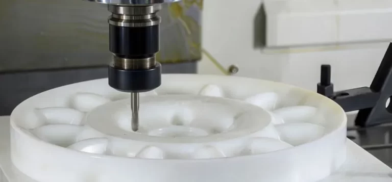 A CNC mill cutting a large white circular nylon (polyamide) workpiece