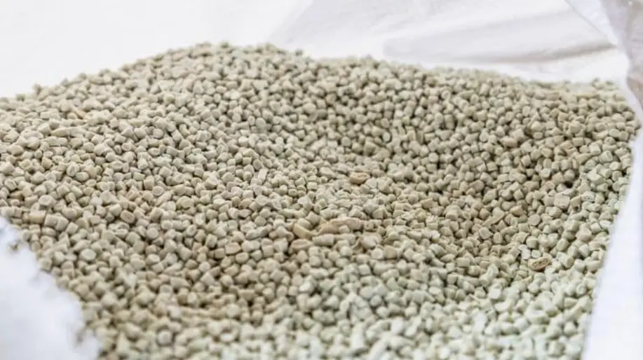 Gray PEEK resin pellets used as raw material feedstock for injection molding