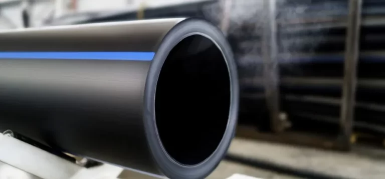 A close-up of a thick-walled black polyethylene pipe with a blue stripe