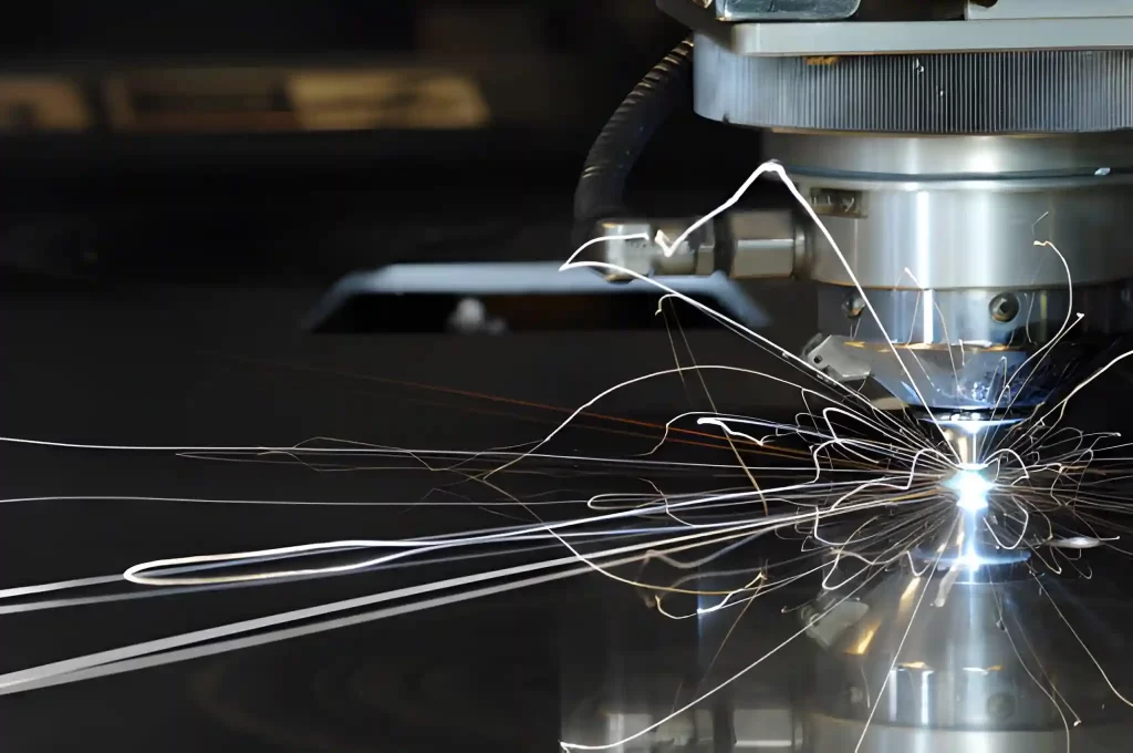 A close-up of a laser cutting machine producing bright sparks while precisely cutting through a metal sheet.