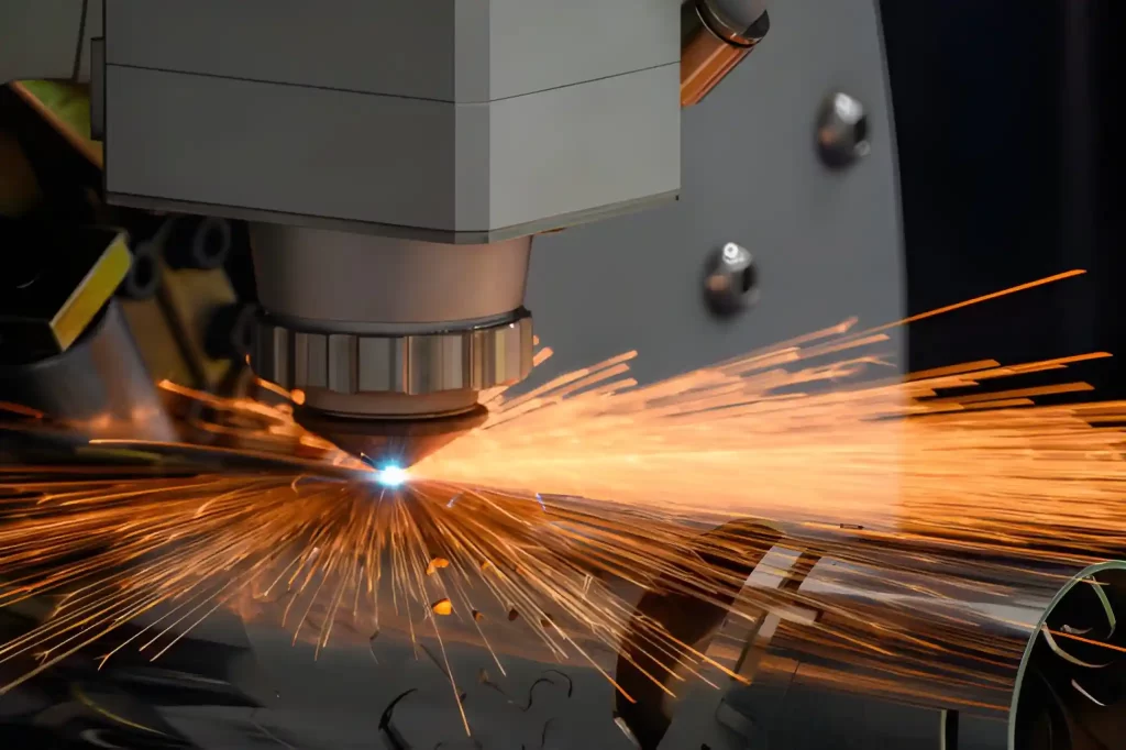 A laser cutting machine precisely cuts a stainless steel pipe, producing clean and accurate holes.