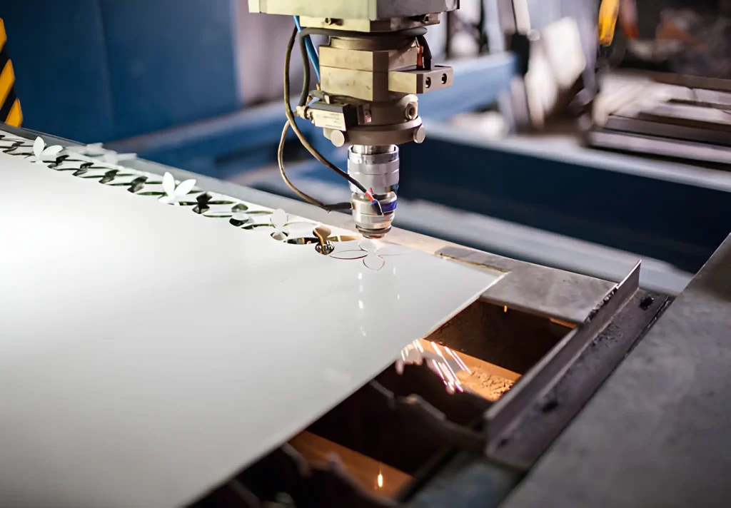 A steel sheet being laser cut into a detailed flower-like pattern.