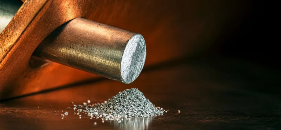 fine gray aluminum metal powder onto a dark, polished wooden table