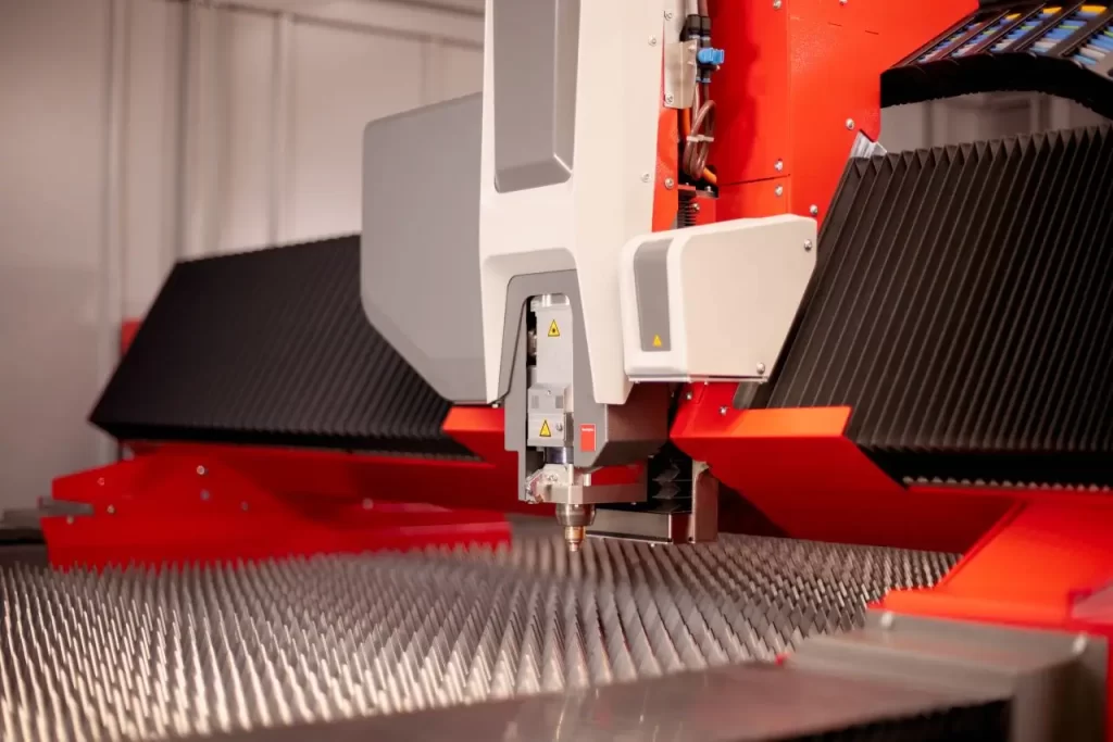 Close-up of a fiber laser cutting machine processing metal with precision.