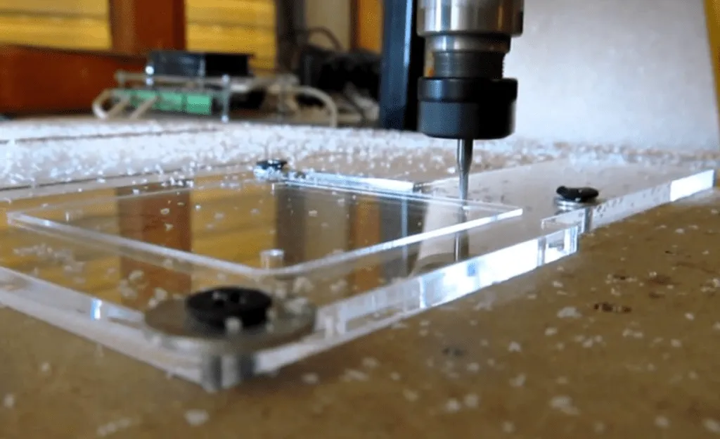 a polycarbonate sheet placed on a work workstation, and a cutter making the cuts in a square shape
