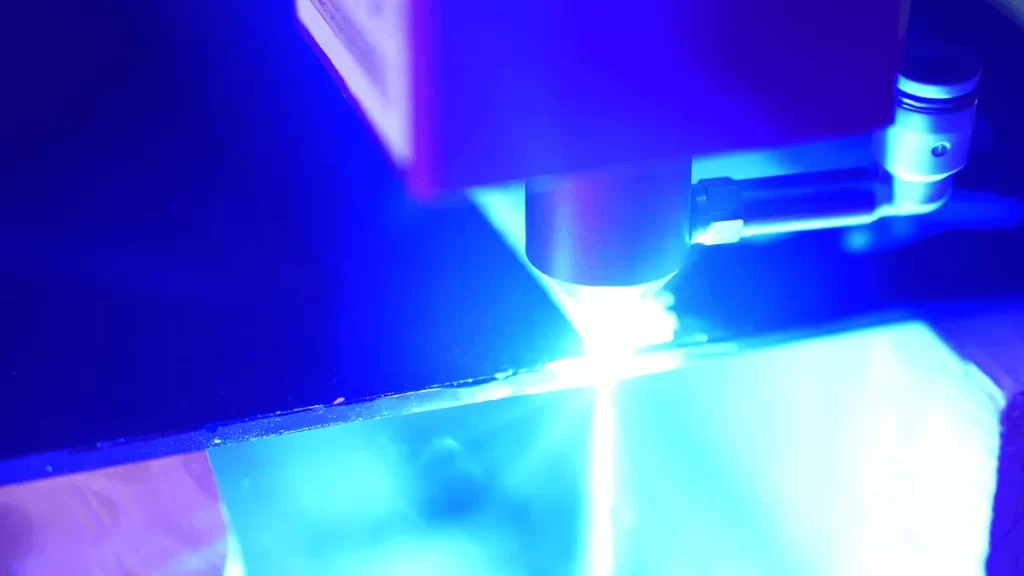 close-up view of a strong beam of laser cutting glass horizontally