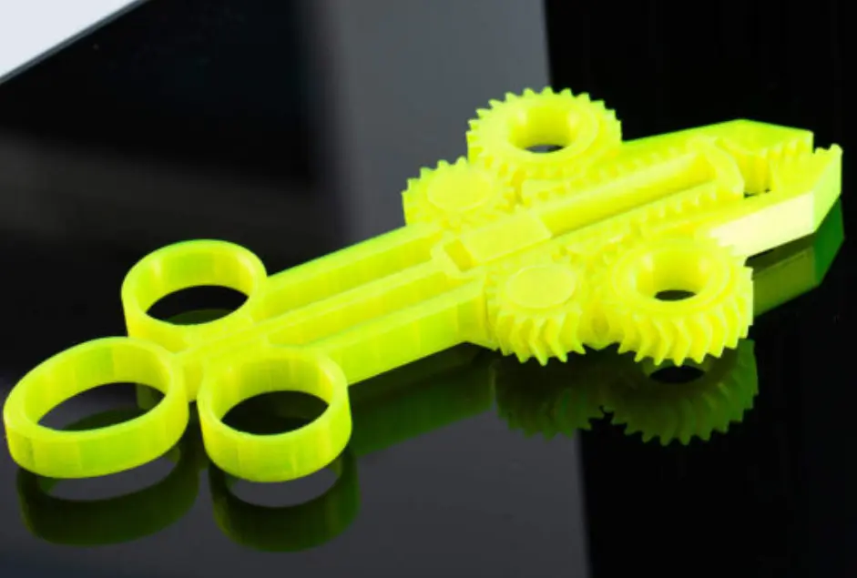 Yellow 3D-printed ABS prototype with interlocking gears and ring-shaped grips