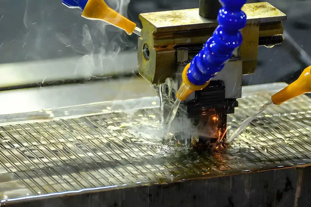 The EDM machine is working with a graphite electrode.