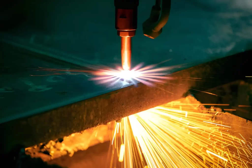 Industrial CNC plasma machine cutting of a metal plate