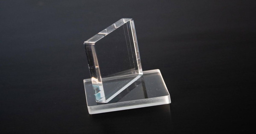 Two polished acrylic parts in blackground