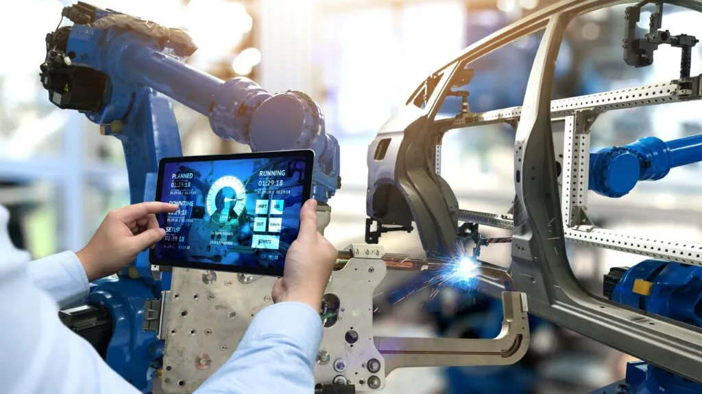 A worker maintaining the quality standards for the EV parts