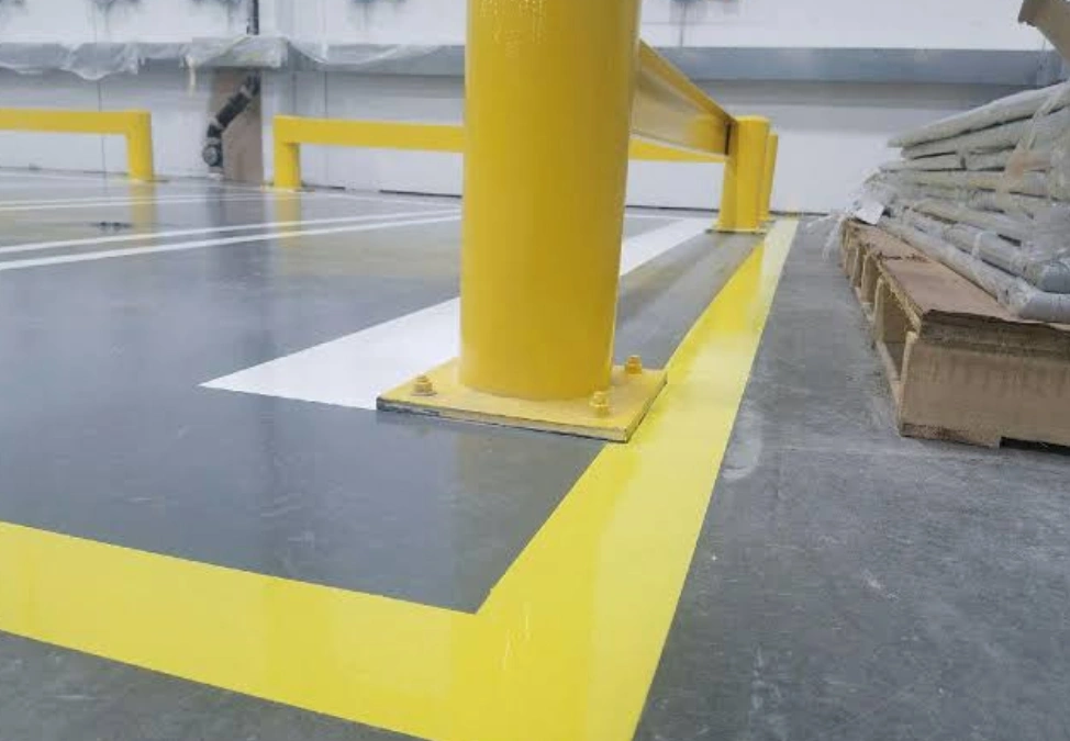 Epoxy-coated warehouse floor with yellow safety line markings