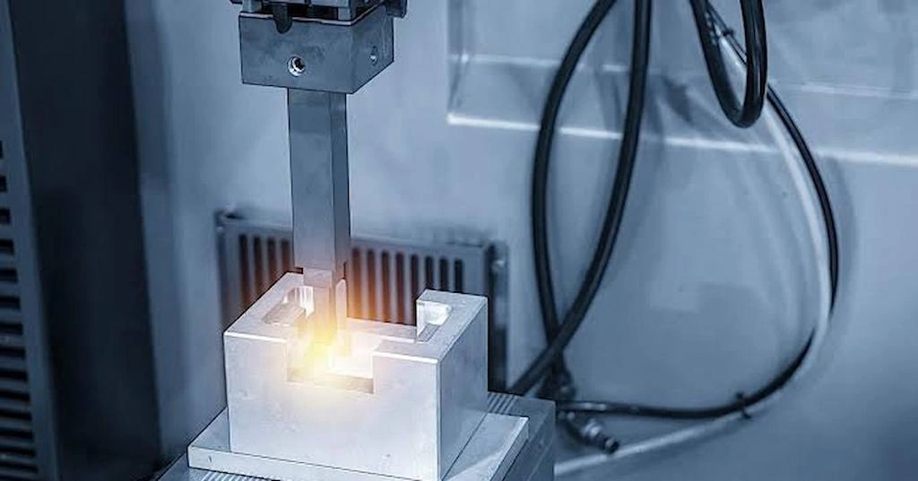 A close-up view of EDM machine cutting cavity in a die