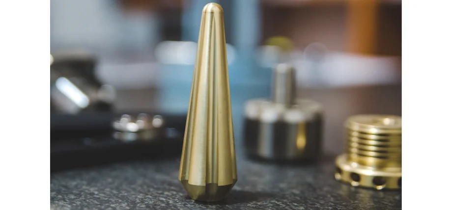 Polished brass center punch with a conical pointed tip