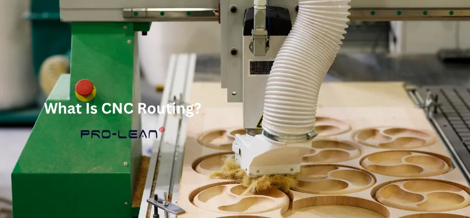 Green industrial CNC router with dust extraction hose actively cutting intricate circular patterns into light-colored wood sheet on a workshop table.