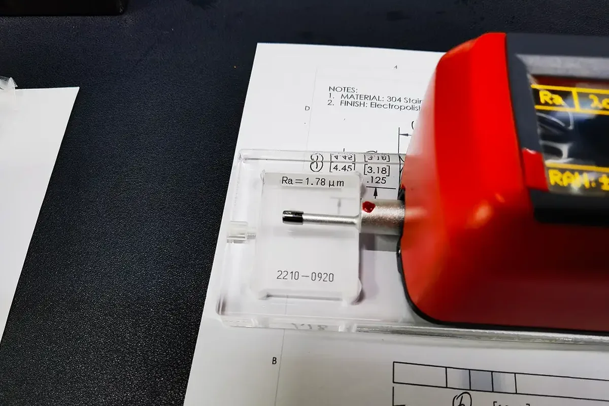 Surface roughness tester measuring Ra on a machined part against the drawing call-out