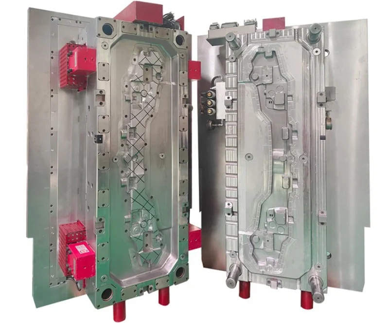 Two halves of a large industrial insert injection mold showing complex cavity geometry with guide pins and red locator blocks.