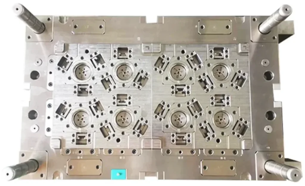 A precision-machined multi-cavity injection mold with eight identical circular cavities arranged in a grid pattern