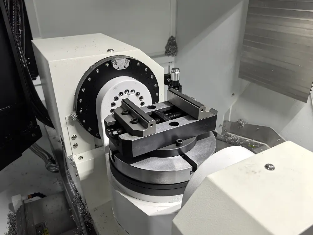 Five-axis CNC machining centre with a part set up