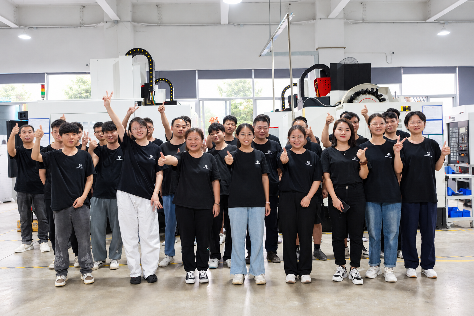 ProleanTech team standing together in the CNC workshop