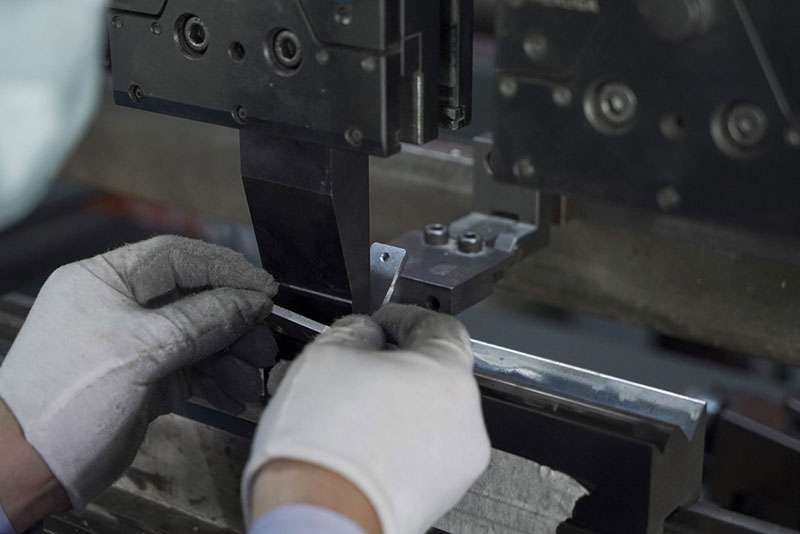 Press brake bending a metal sheet between punch and die