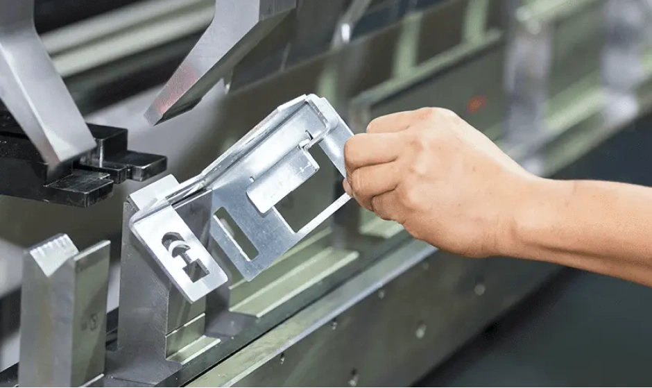 Operator forming a sheet metal component on a press brake