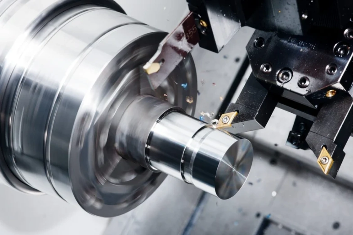 Lathe tool cutting a cylindrical workpiece held in a chuck
