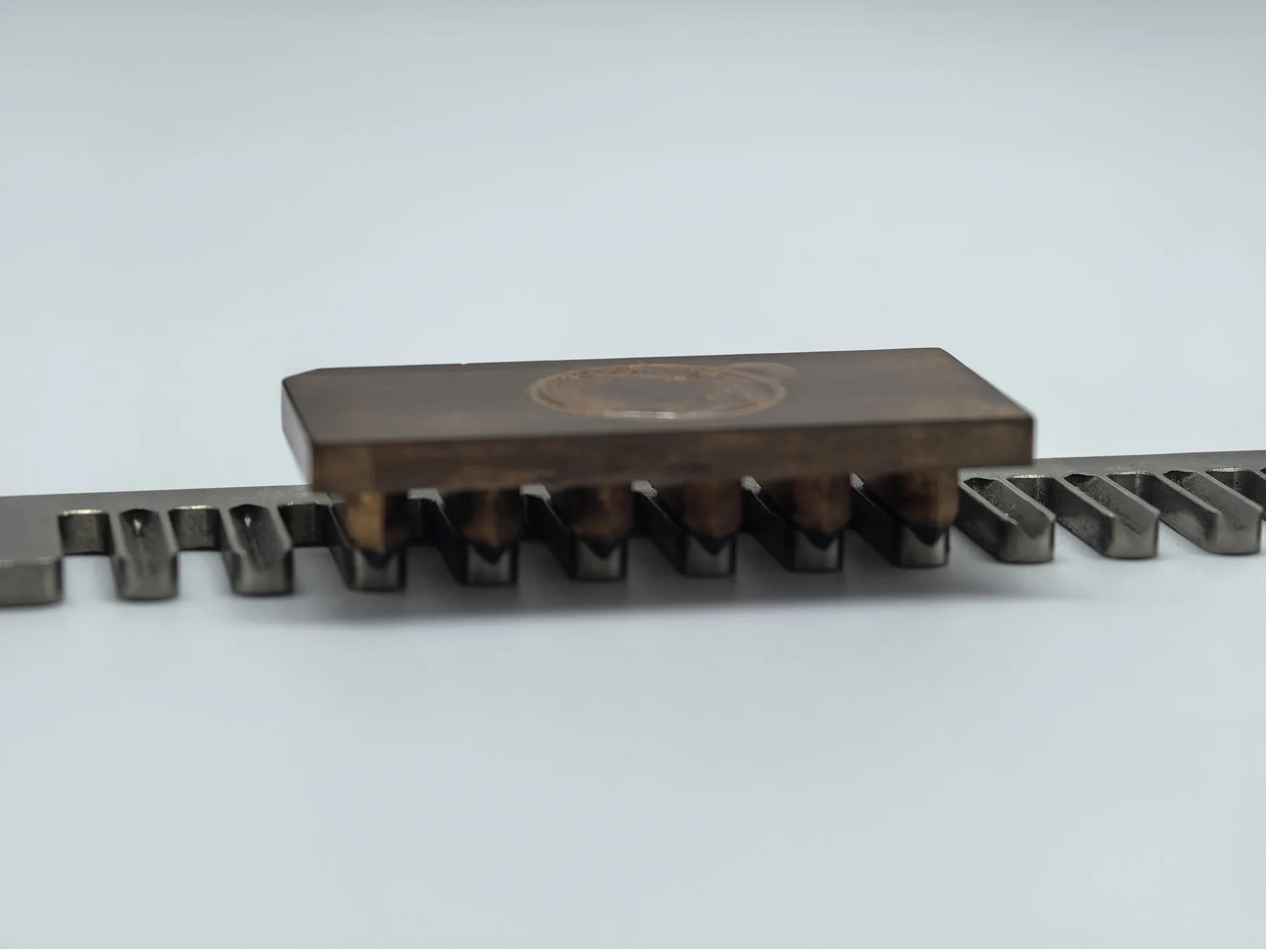 Front view of the copper sinker EDM electrode and slotted metal workpiece