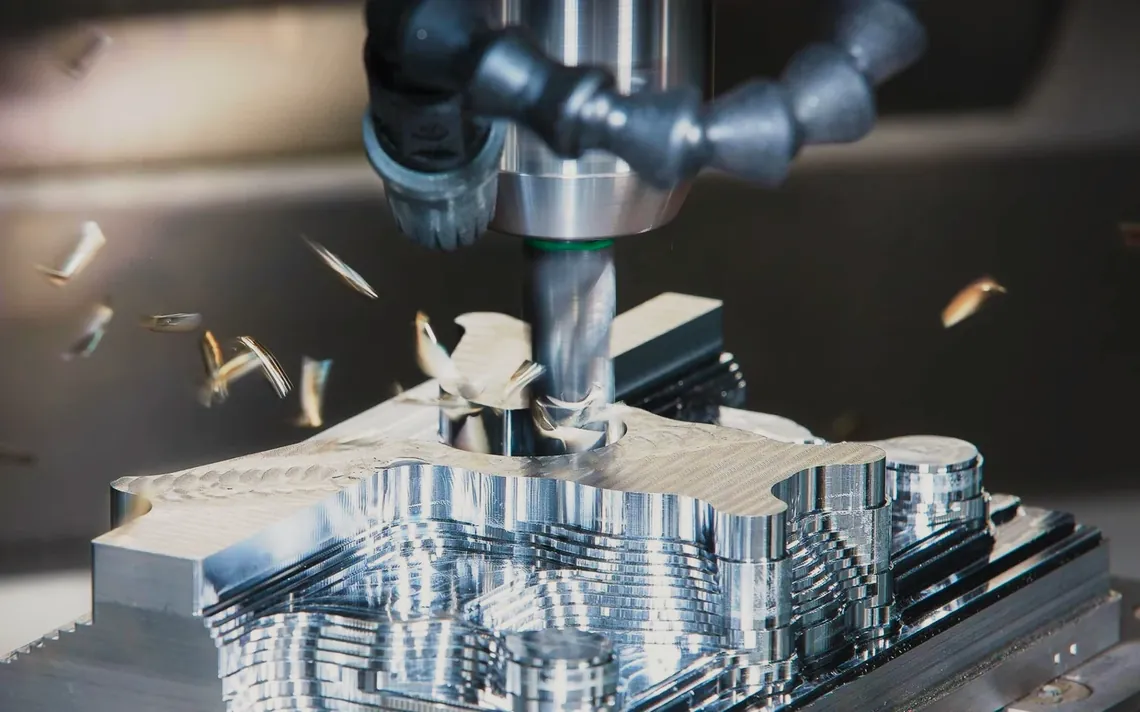 Close view of CNC cutting a metal component