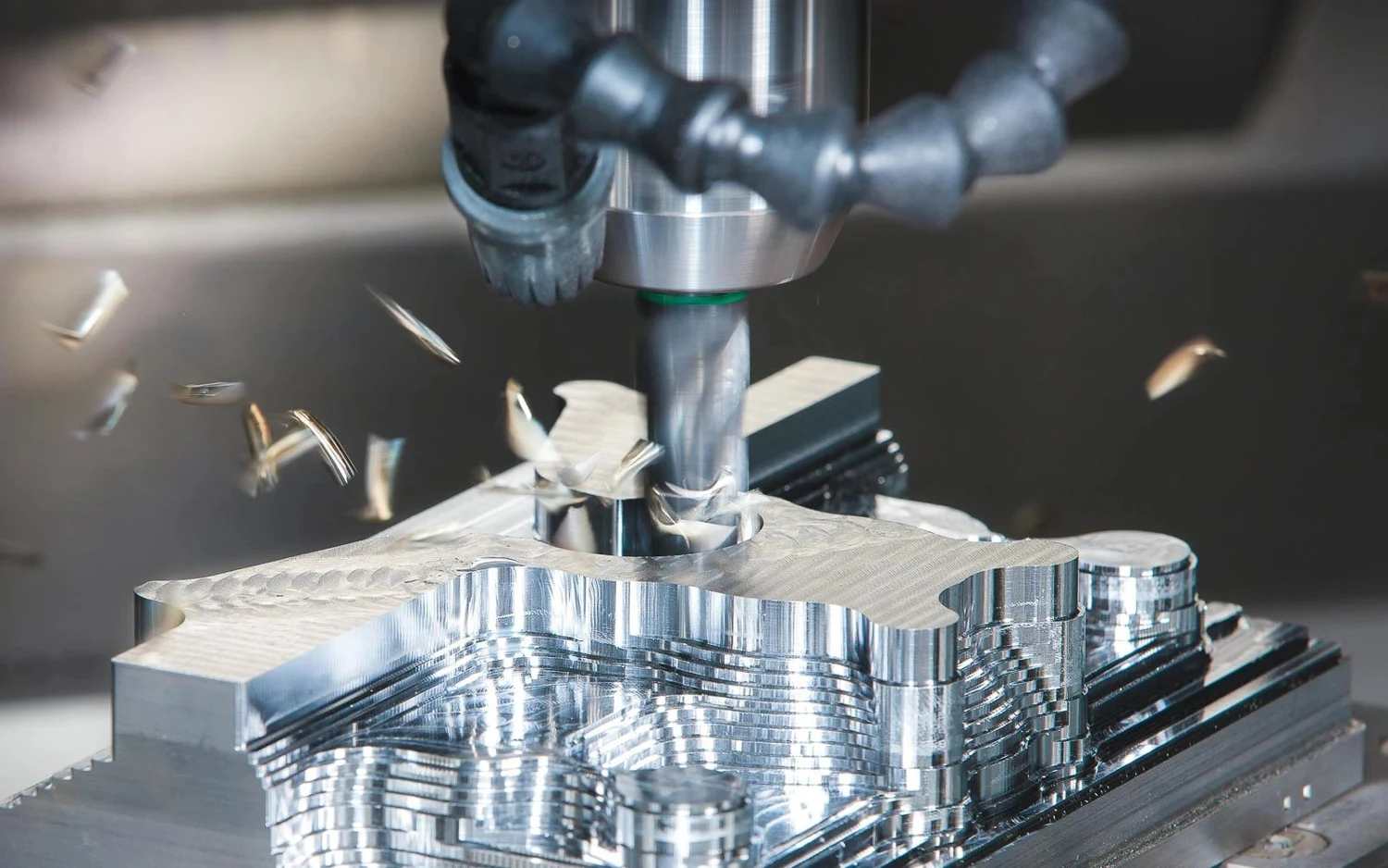 Close view of CNC cutting a metal component